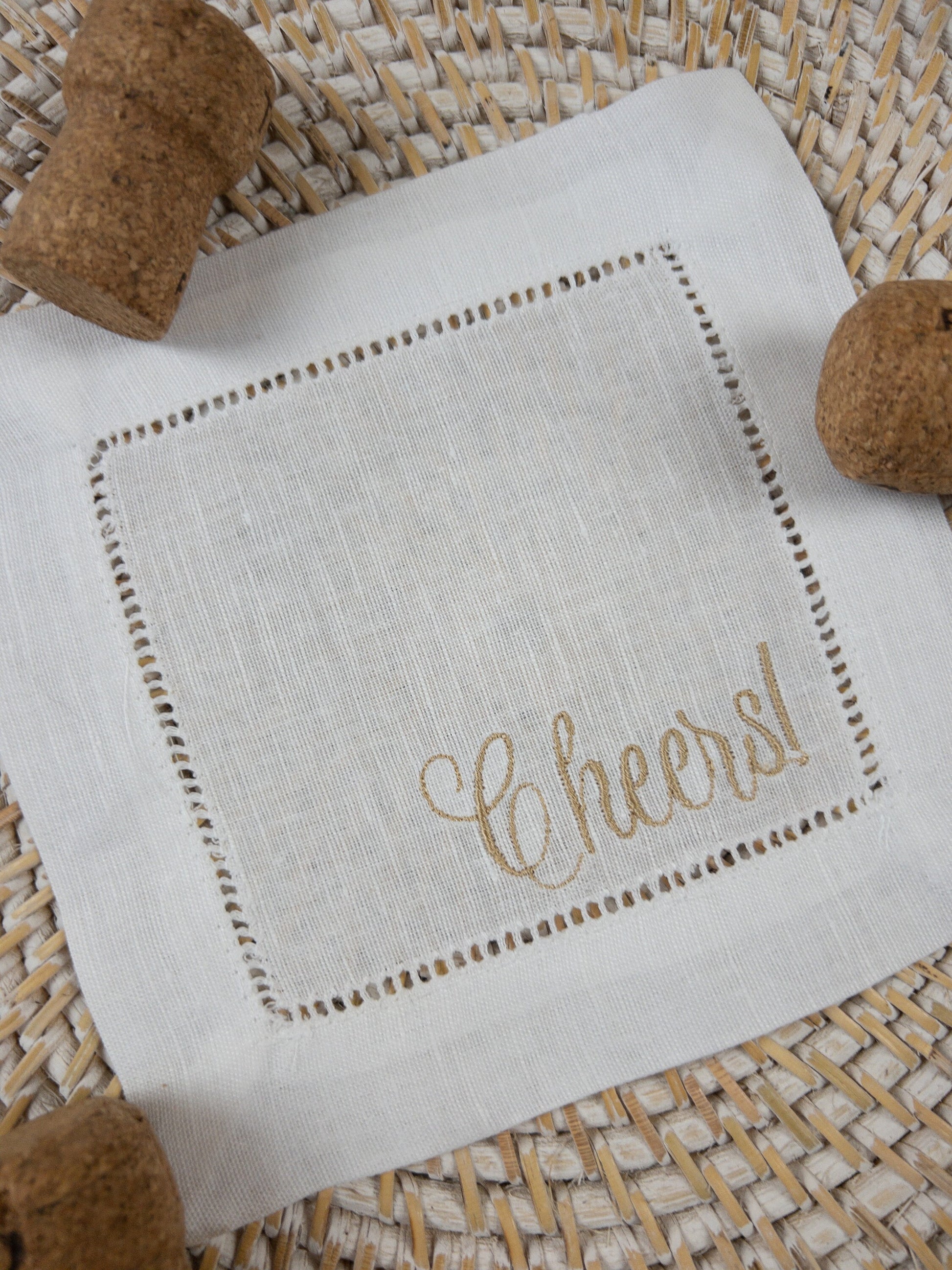White Linen Cocktail Napkin embroidered with Cheers!